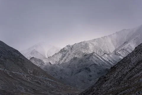 View of snow mountain surrounded by clouds with morning fog Stock Photos