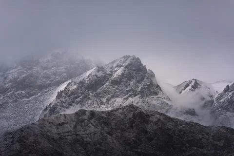 View of snow mountain surrounded by clouds with morning fog Stock Photos