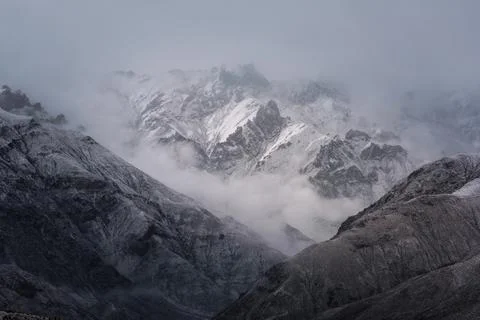 View of snow mountain surrounded by clouds with morning fog Stock Photos