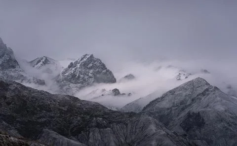 View of snow mountain surrounded by clouds with morning fog Stock Photos