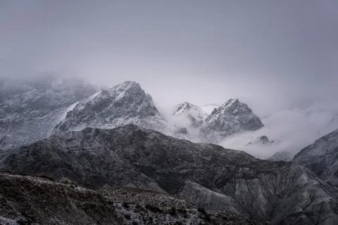 View of snow mountain surrounded by clouds with morning fog 스톡 사진