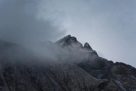 View of snow mountain surrounded by clouds with morning fog Stock Photos
