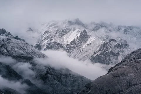 View of snow mountain surrounded by clouds with morning fog Stock Photos