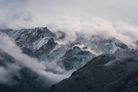View of snow mountain surrounded by clouds with morning fog Stock Photos