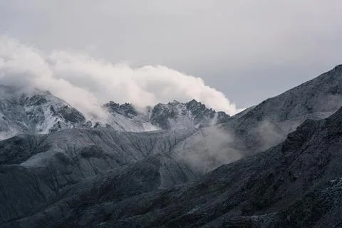 View of snow mountain surrounded by clouds with morning fog Stock Photos