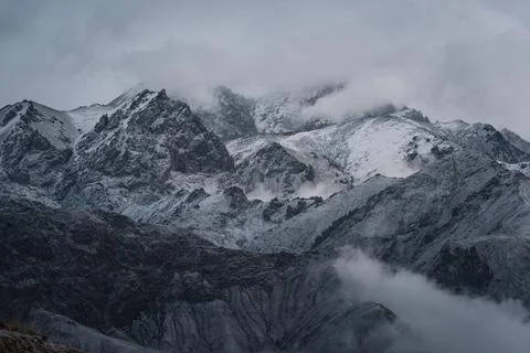 View of snow mountain surrounded by clouds with morning fog Stock Photos