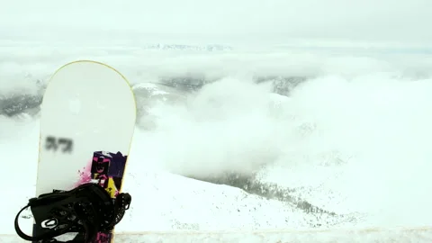View of snowed mountains snowboard in front Stock Footage 221548803