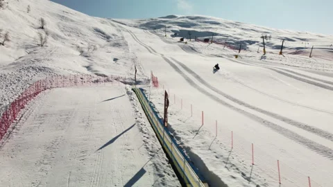 A view of a snowmobile climbing to the top of the mountain, in Italy. Stock Footage 152987007