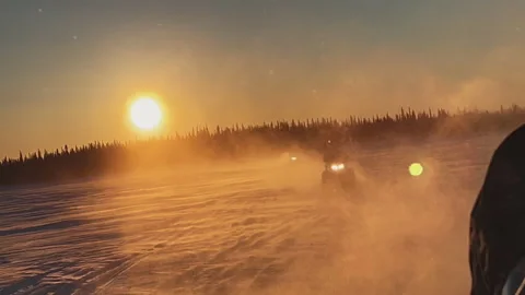 View from the snowmobile at speed. Red sun at sunset Stock Footage 219628116