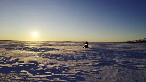View from the snowmobile at speed. Red sun at sunset Stock Footage 244481289