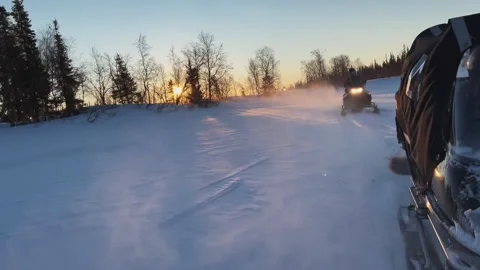 View from the snowmobile at speed. Red sun at sunset Stock Footage 244481734