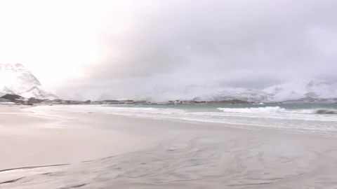 View of a snowy beach with mountains in the background in Lofoten, Norway Stock Footage 136774174