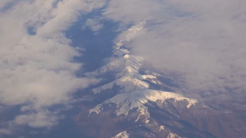 View from the snowy gorge in the mountains to the clouds and the city smog Stock Footage 103578558