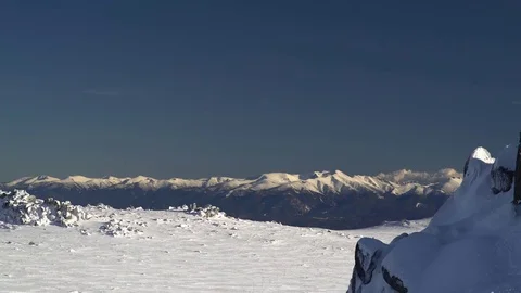 View on Snowy Mountain Peaks in the Winter Sun 4K Stock Footage 76516932