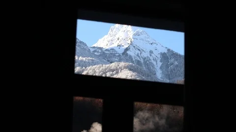 View of the snowy mountains from the hotel window with smoke Stock Footage 101018311