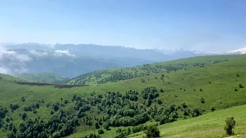 View of the snowy peak of mount elbrus and the green caucasian mountains Stock Footage 202188387