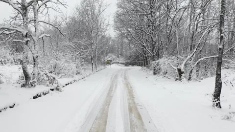 View to a snowy road in the forest at winter in the mountain 스톡 동영상 328227805