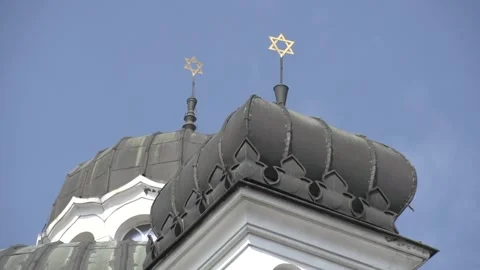 View of Sofia Synagogue dome and Stars of David in bright blue sky 動画素材 329458239