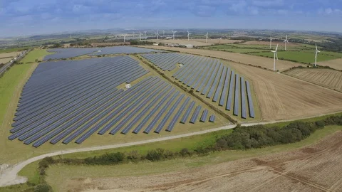 A View of Solar Panels and Wind Turbine in the Field 스톡 동영상 127798683
