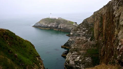 View of South stack lighthouse from cliff side duing a dull cloudy day in north Stock Footage 162504100