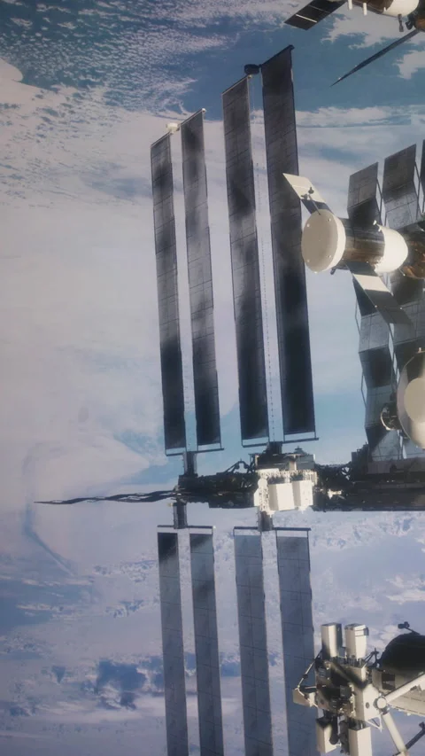 View of space station above Earth with solar panels and blue planet below Stock Footage 344963596