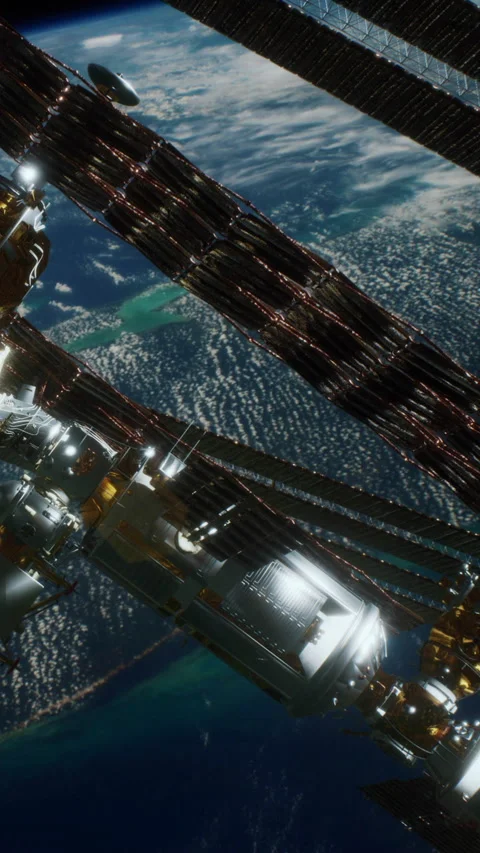 View of a space station orbiting Earth with bright clouds below Stock Footage 344960232