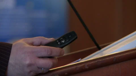 View of speaker's hand with remote control Video stock 63331424
