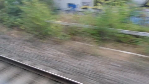 View from speeding railway train flashing fast past window. London Stock Footage 205572125