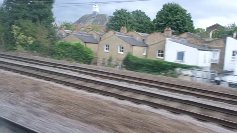View from speeding railway train flashing fast past window. London Stock Footage 205572178