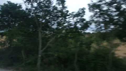 View from speeding railway train flashing fast past window. London Stock Footage 205572182
