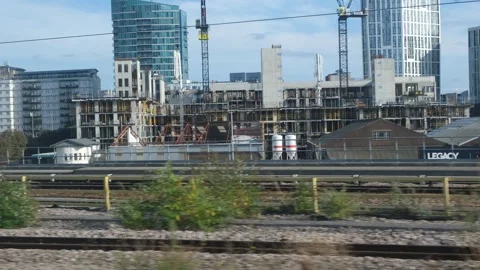 View from speeding railway train window flashing past. East London Stock Footage 289852443