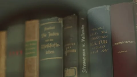 View of spines of old books in German standing in bookcase in royal library. Stock Footage 198921990