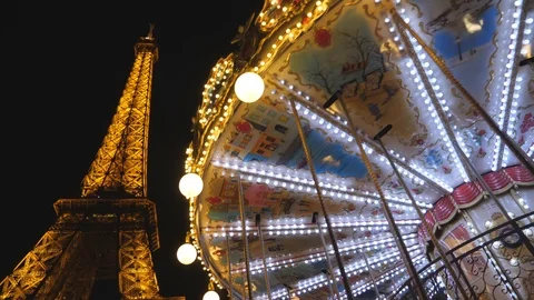 View of spinning carousel with Eiffel tower in background. Paris, France. Video stock 98702713