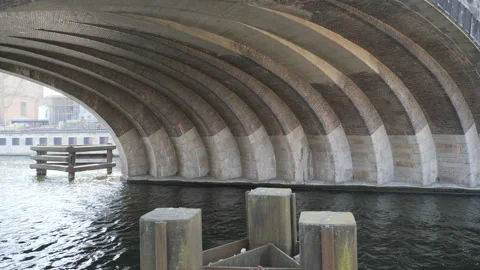 A view of the Spree river from underneath an arched bridge. Stock Footage 172272865
