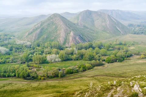 View of the spring mountain landscape through the misty haze Stock Photos