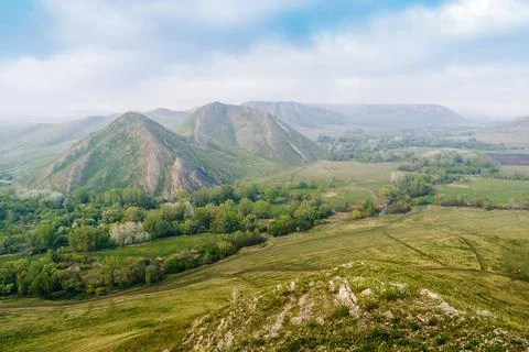 View of the spring mountain landscape through the misty haze Stock Photos