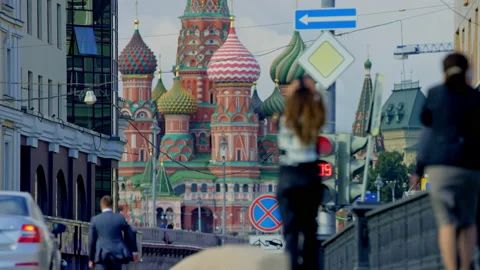 View of St. Basil's Cathedral, Moscow. Pretty girl is walking across the bridge. Stock Footage 158433435