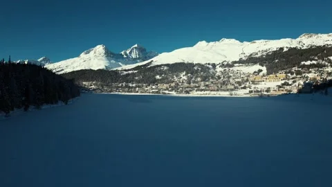 View of the St. Moritz village with snow covered mountains in the background. Video stock 295883409