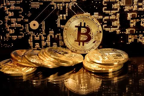 View of a stack of bitcoins on background of electronic schemes Stock Photos