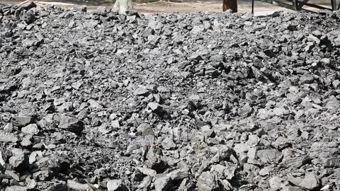 A view of stacked charcoal heaps isolated at the factory yard during summer Stock Footage 245091047