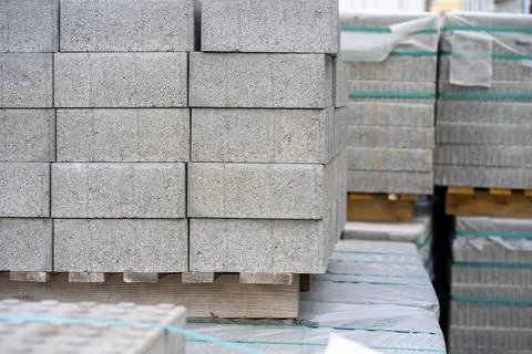 View of stacked gray paving slabs on a wooden pallet at a construction site Foto stock