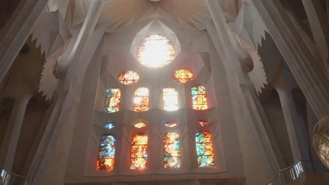 View of stained-glass window in wall of Sagrada Familia cathedral. Bright sun Stock Footage 117160000