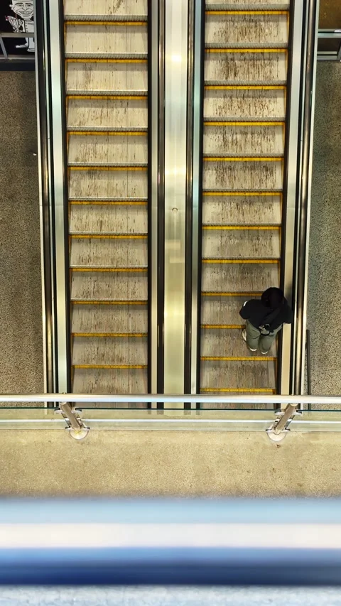 View of stairs and escalator inside a building with metal railings and floor Stock Footage 332272797