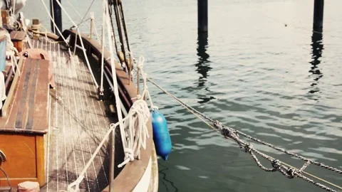 View of the starboard side of a sailing ship moored in the port Vídeos de archivo 258555459