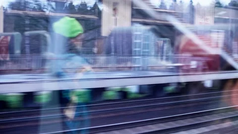 View of station and forest from the window of passing by train. Railway Stock Footage 147725290
