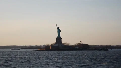View of the Statue of Liberty from a ferry at sunset Stock Footage 136207568