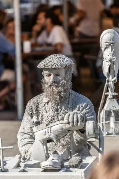 View of statue man, doing shoemaker acting on the street, Porto city, Portuga Stock Photos