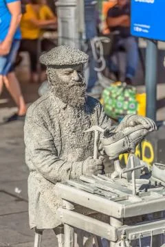View of statue man, doing shoemaker acting on the street, Porto city, Portuga Stock Photos