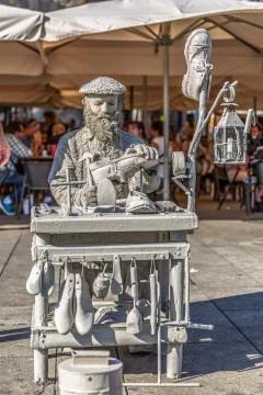View of statue man, doing shoemaker acting on the street, Porto city, Portuga Stock Photos