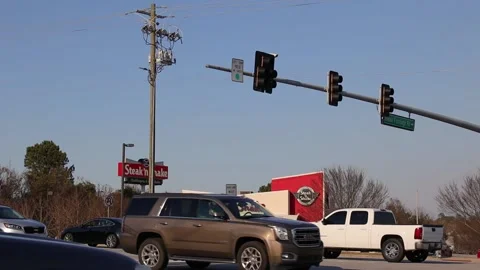 View of Steak n Shake through traffic on the road way turn signals and power  Stock Footage 149223613